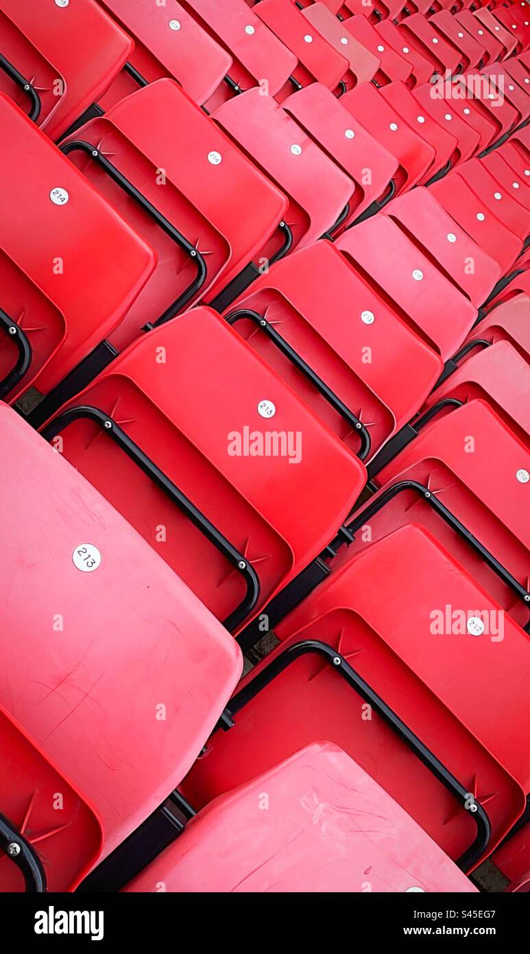 Red sports stadium seats taken on an angle to create a diagonal effect