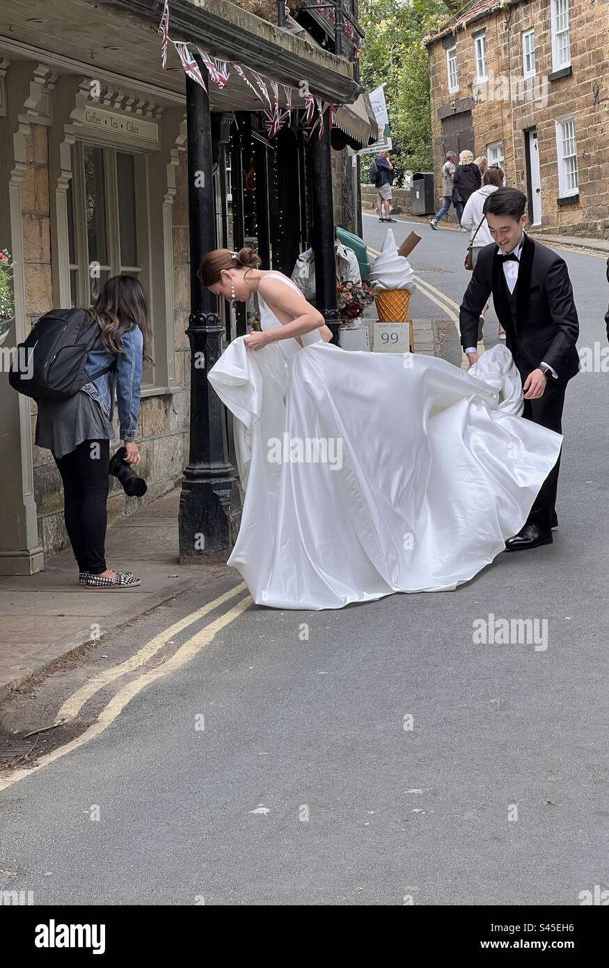 Couple with photographer on a wedding shoot - Smartphone Captured Stock Image
