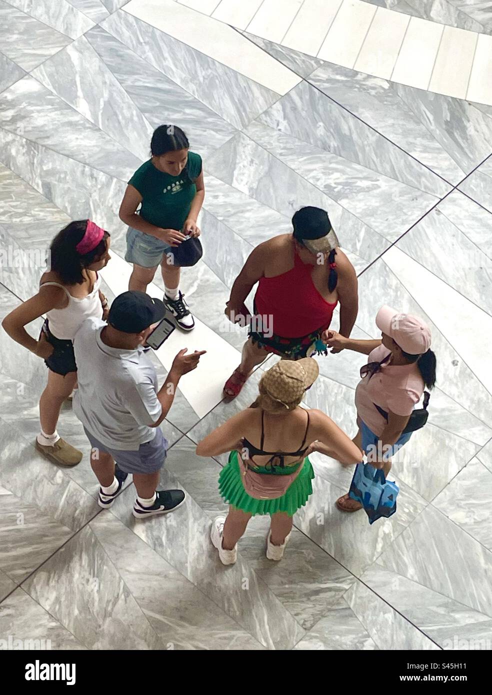 Looking down at a group of people in a mall - Smartphone Captured Stock Image