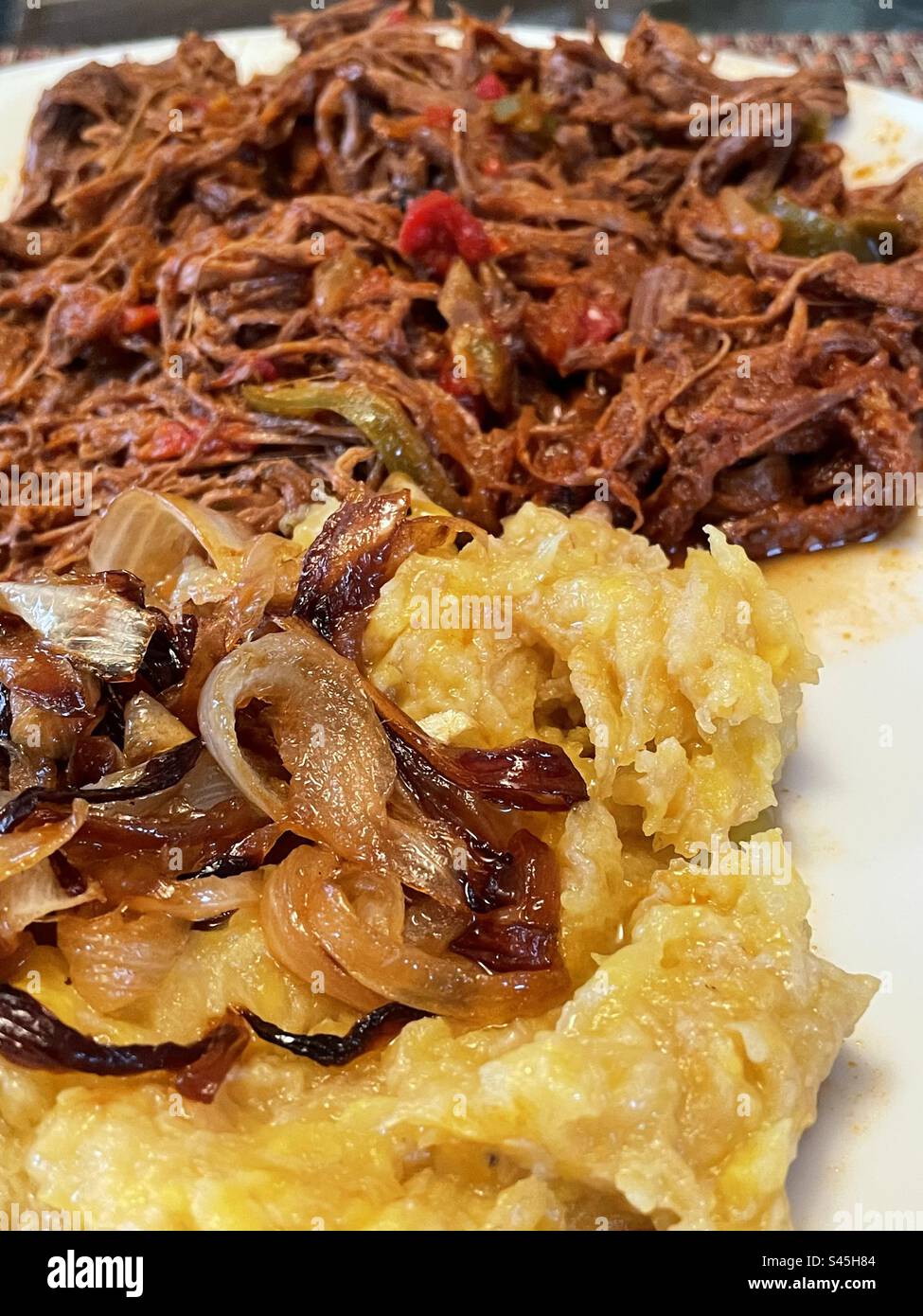 “Ropa vieja” literally Old Clothes is made with shredded flank steak