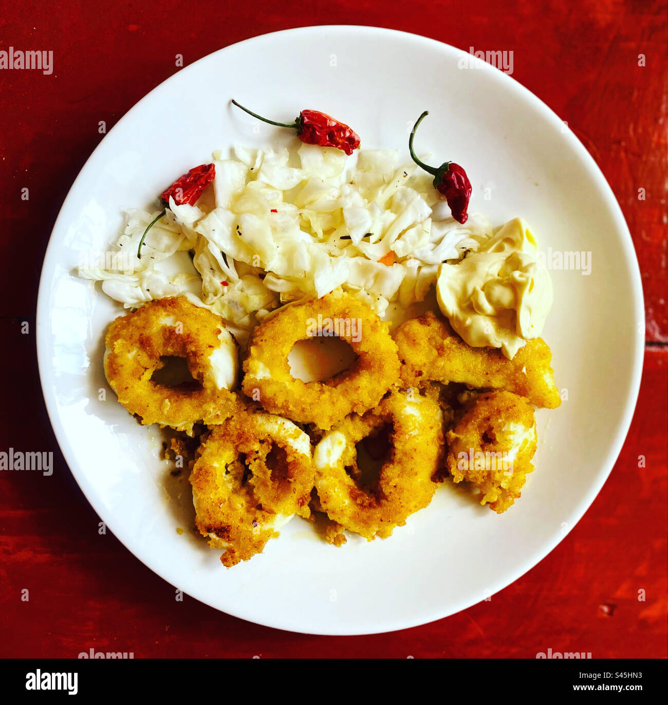 Breaded squid, pickled cabagge, mayonaisse and red hot chilli peppers in Queretaro, Mexico - Smartphone Captured Stock Image