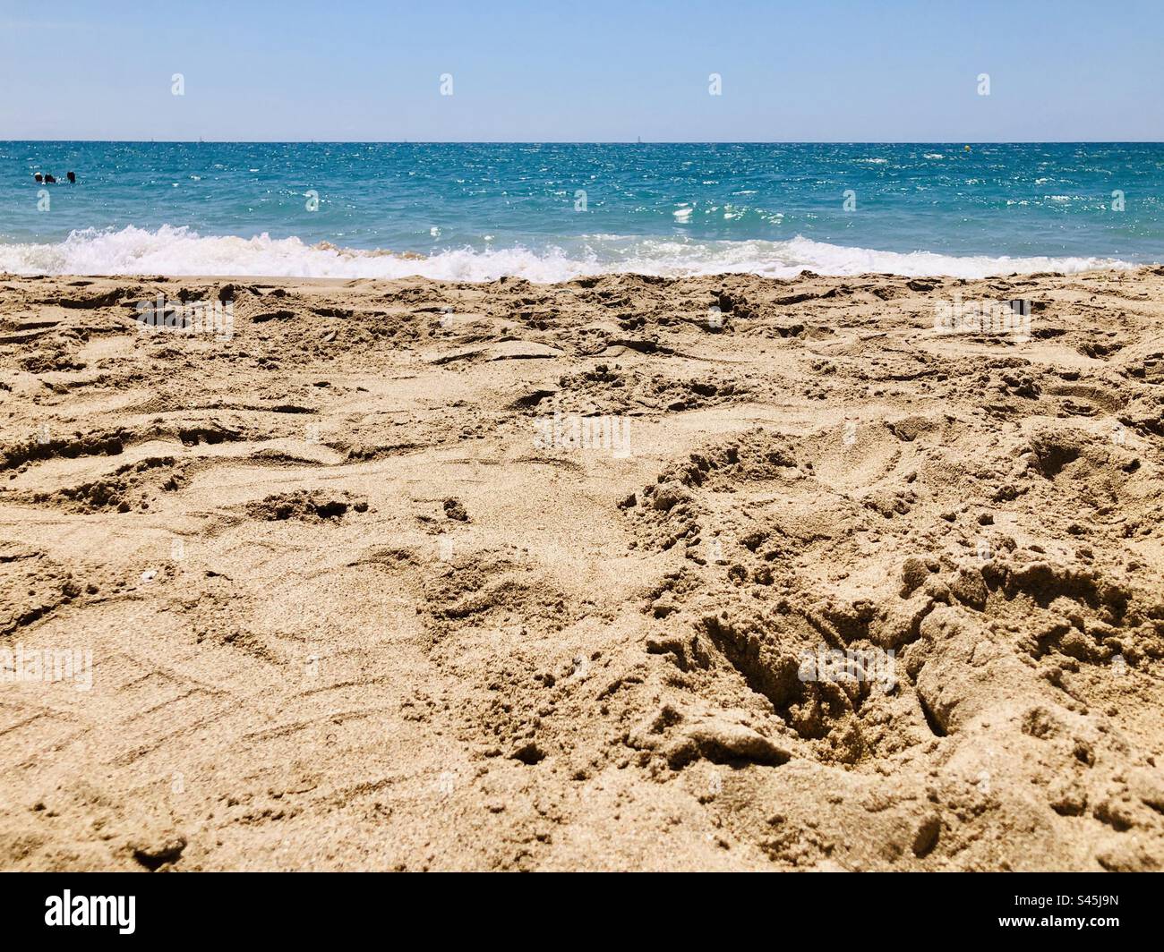 Seascape on the shore of Costa Daurada, Spain. Beach with gold sand and turquoise water. Mediterranean sea - Smartphone Captured Stock Image