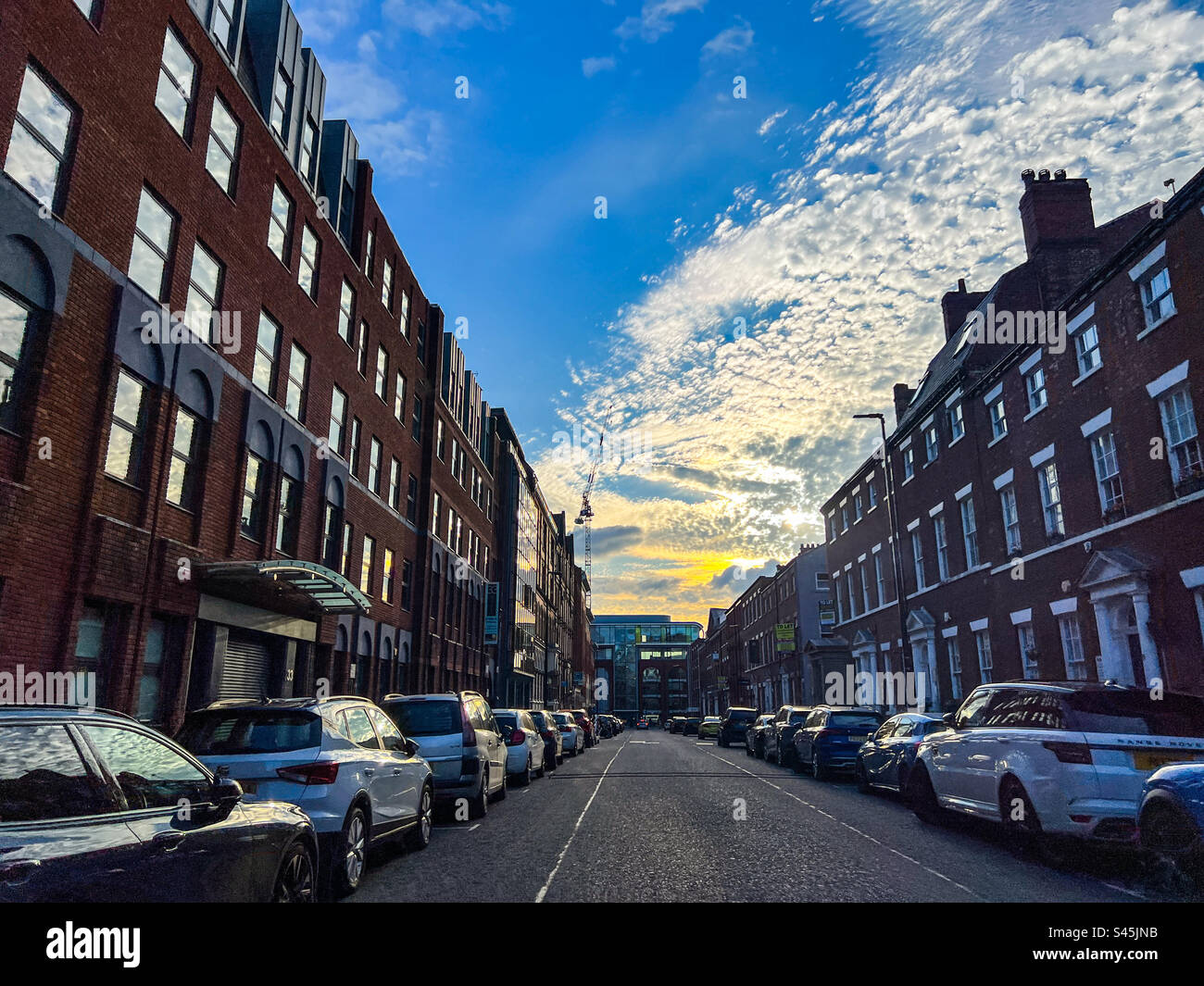 Cars parked down Park Place in Leeds City Centre during sunset - Smartphone Captured Stock Image