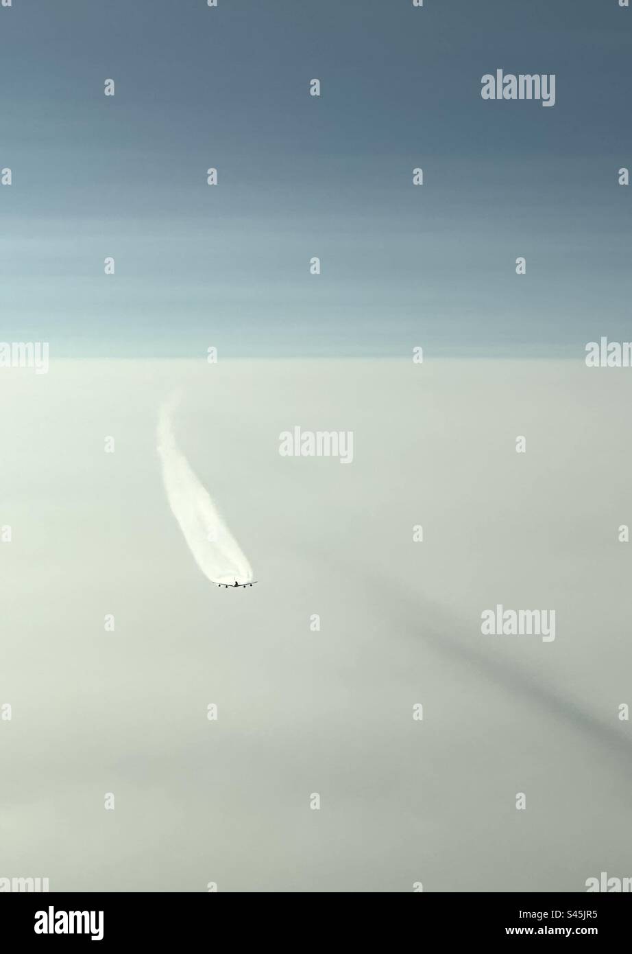 Boeing 747 cruising at 37,000ft with con trails extending back. - Smartphone Captured Stock Image