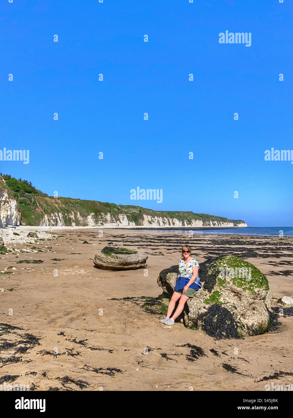 Woman on the beach at Danes Dyke East Yorkshire Stock Photo