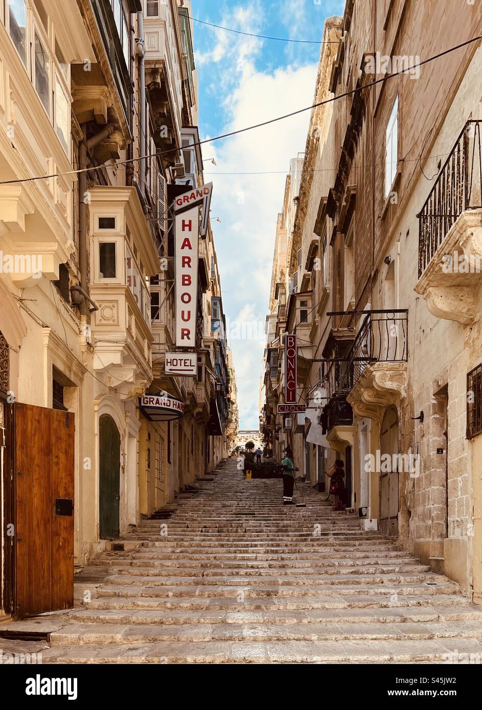Steps and shop signs of St. Ursula street in Valletta, the capital of Malta Stock Photo