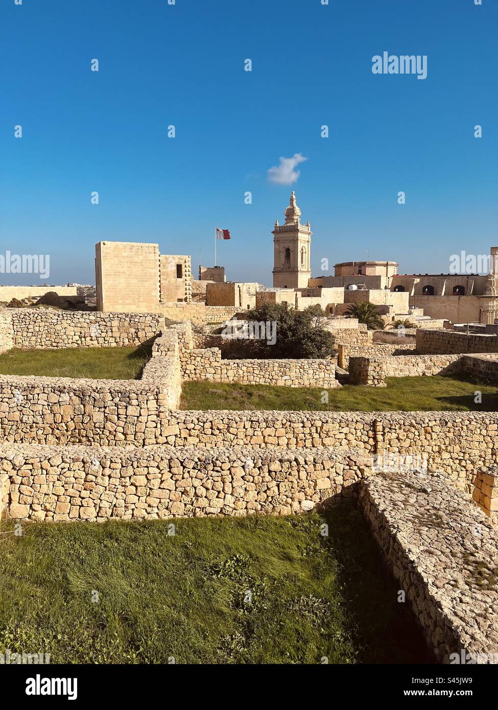 Green roofs and stone walls of the old town Citadel on the Gozo island in Malta - Smartphone Captured Stock Image