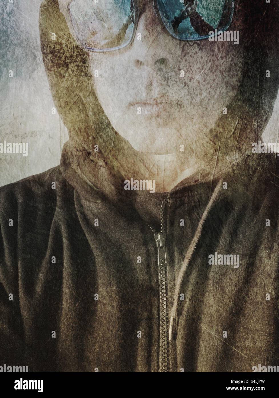 Mood portrait with impressionist tone of male with sunglasses and hoodie. Close up portrait - Smartphone Captured Stock Image