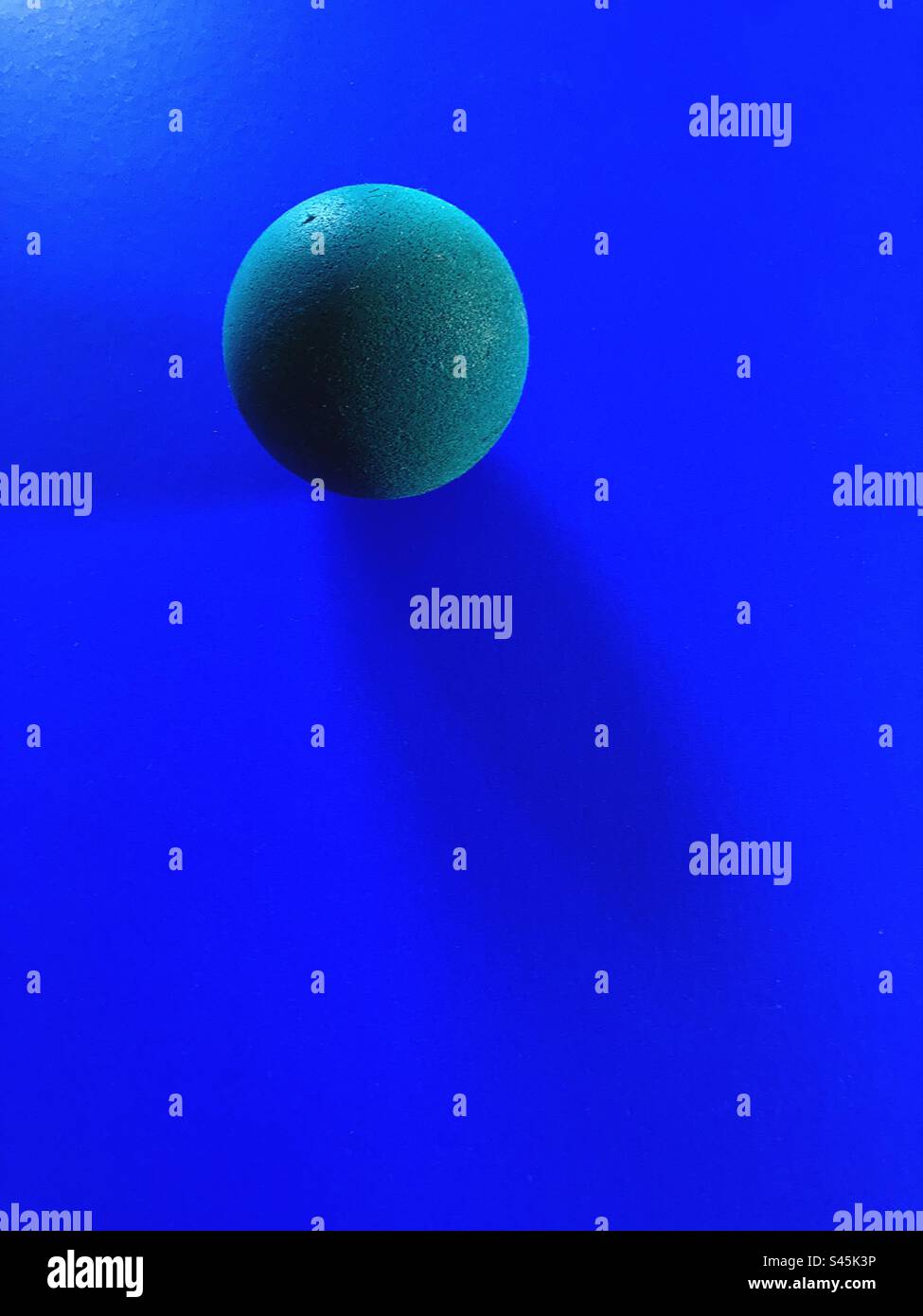 Blue ball isolated  on blue background,still life object. - Smartphone Captured Stock Image