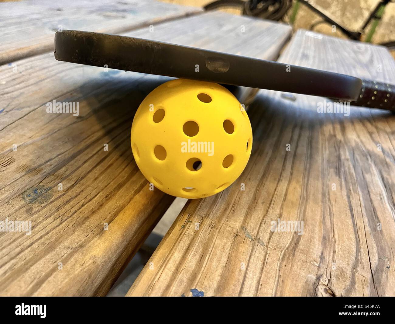 Pickleball and bat on picknick table - Smartphone Captured Stock Image