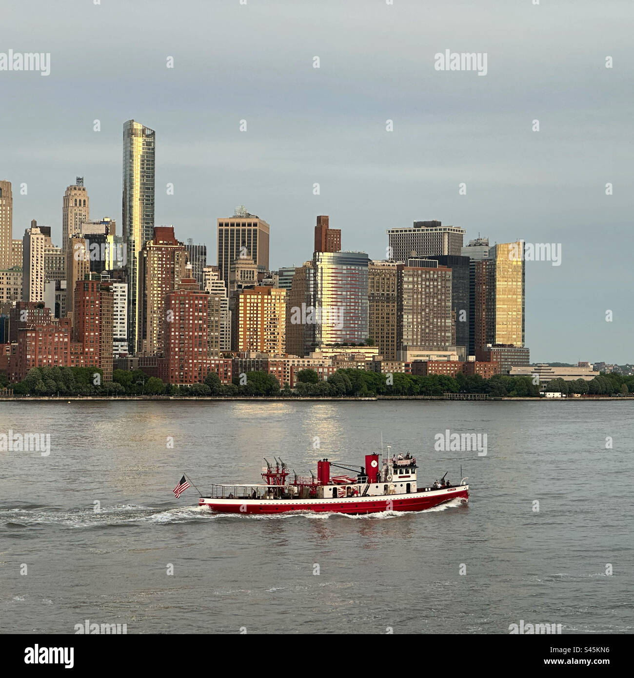 May, 2023, Fireboat on the Hudson River, Lower Manhattan in the background, New York, New York, United States Stock Photo