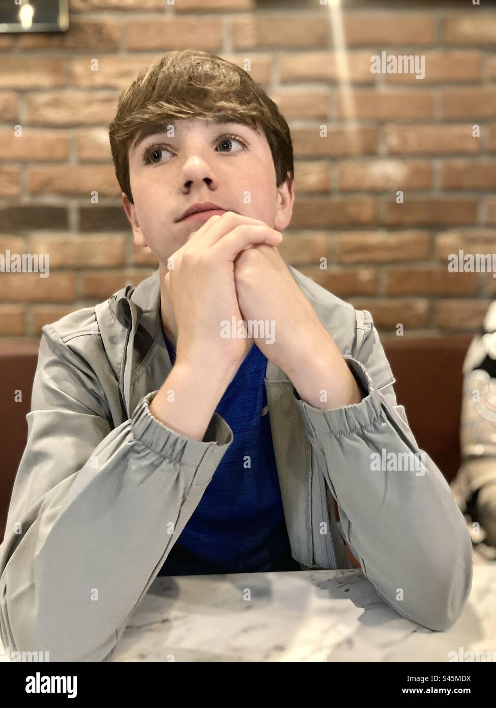 Teenager posing in a thinking pose - Smartphone Captured Stock Image