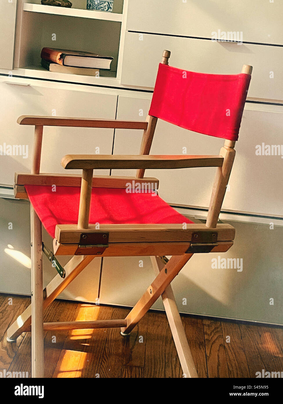 Directors chair with red fabric in a New York City residential apartment, 2023, New York City, USA - Smartphone Captured Stock Image