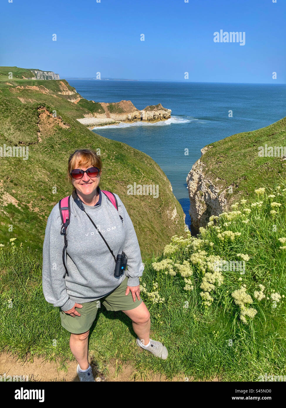 Woman bird watching at Thornwick Bay East Yorkshire - Smartphone Captured Stock Image