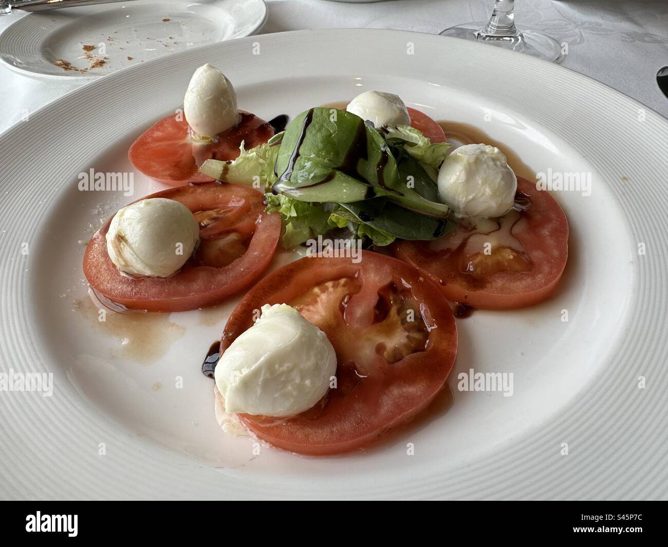 First course, basil, tomato and mozzarella salad Stock Photo
