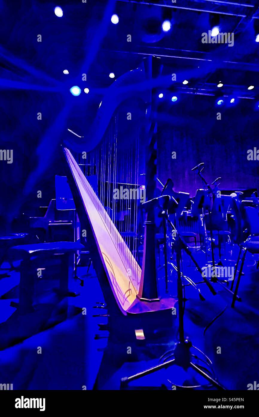 Harp bathed in blue light on stage - Smartphone Captured Stock Image