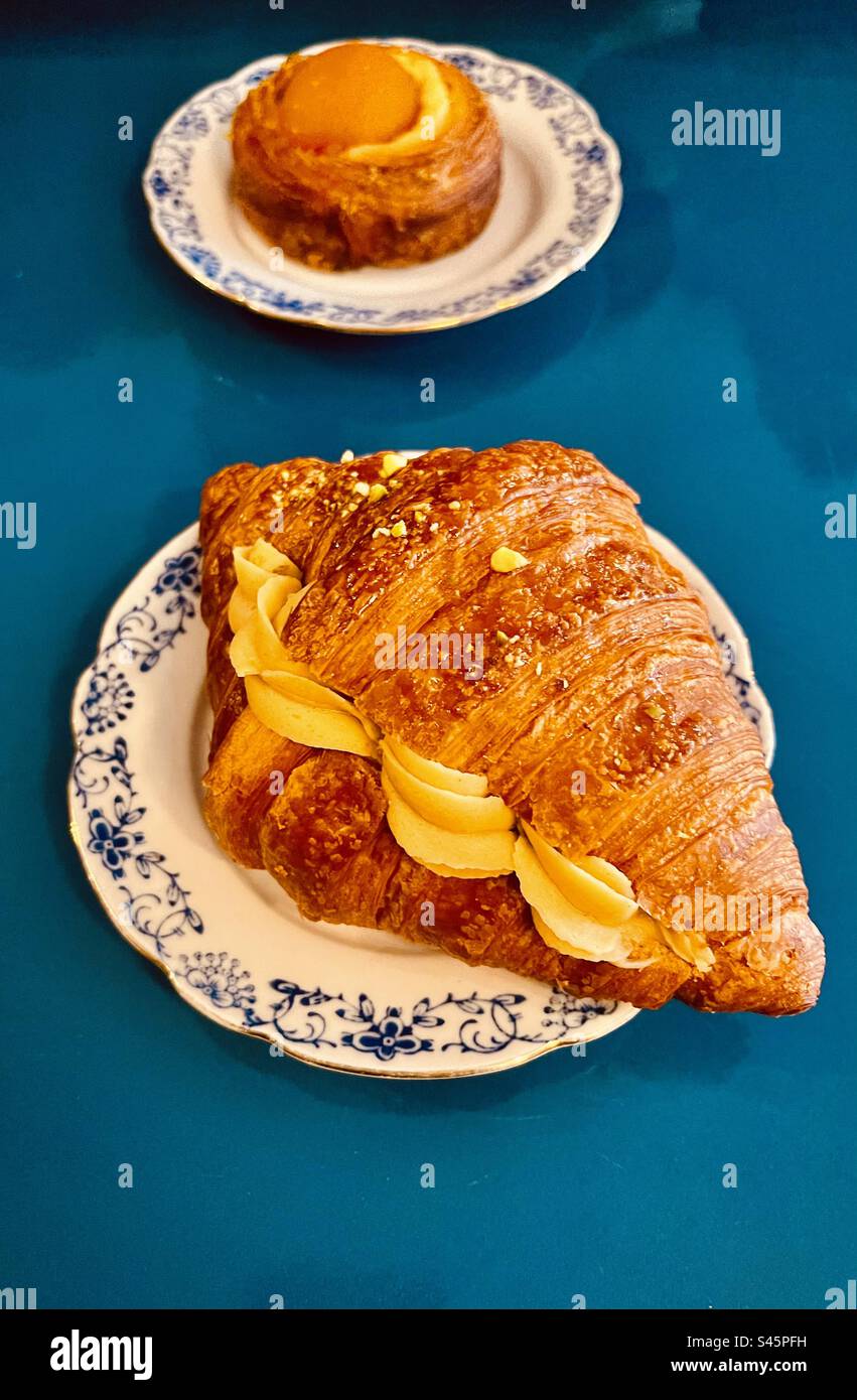 Croissant with Pistachio cream and an Apricot pastry. - Smartphone Captured Stock Image