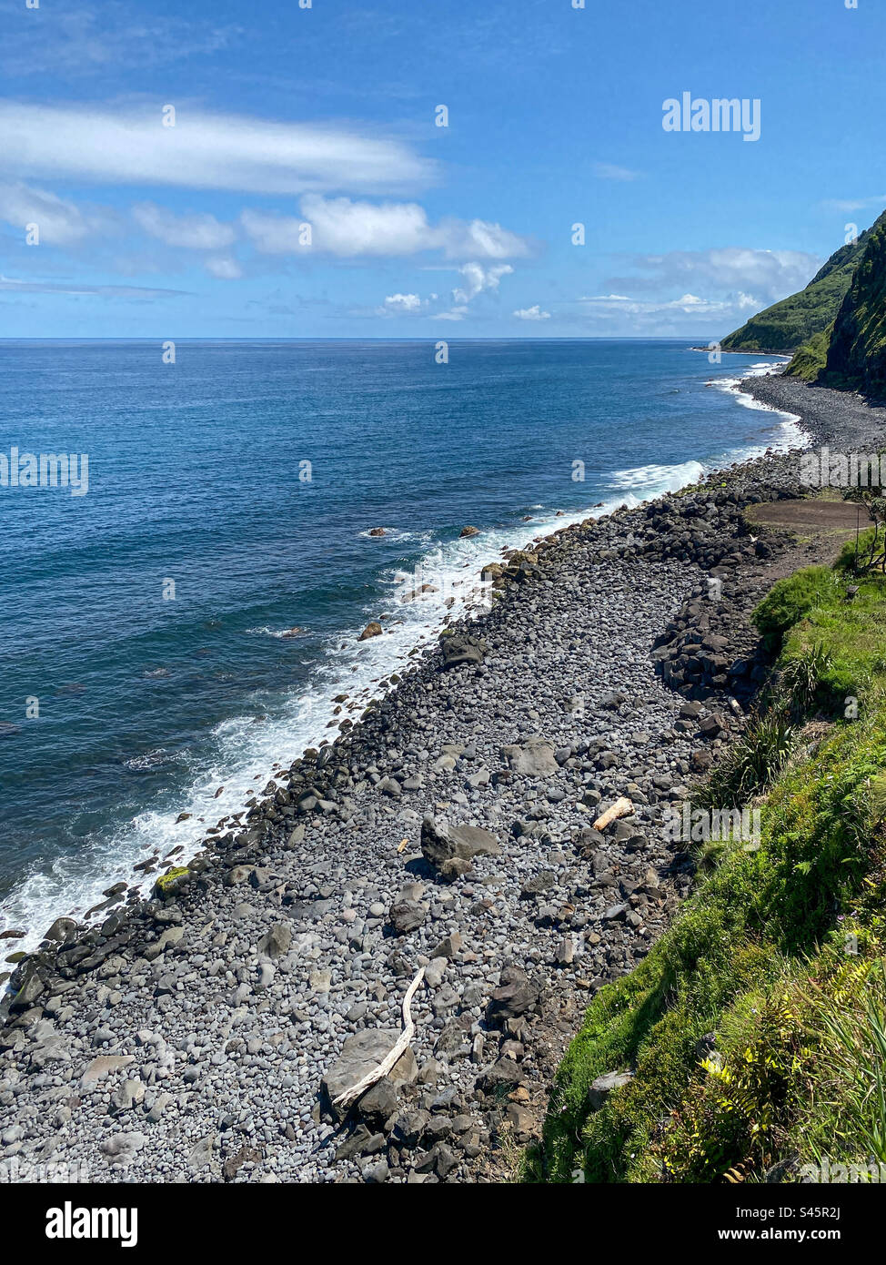 Rocky beach hugs the Atlantic Ocean shoreline of Sao Miguel Island, Azores, Portugal - Smartphone Captured Stock Image