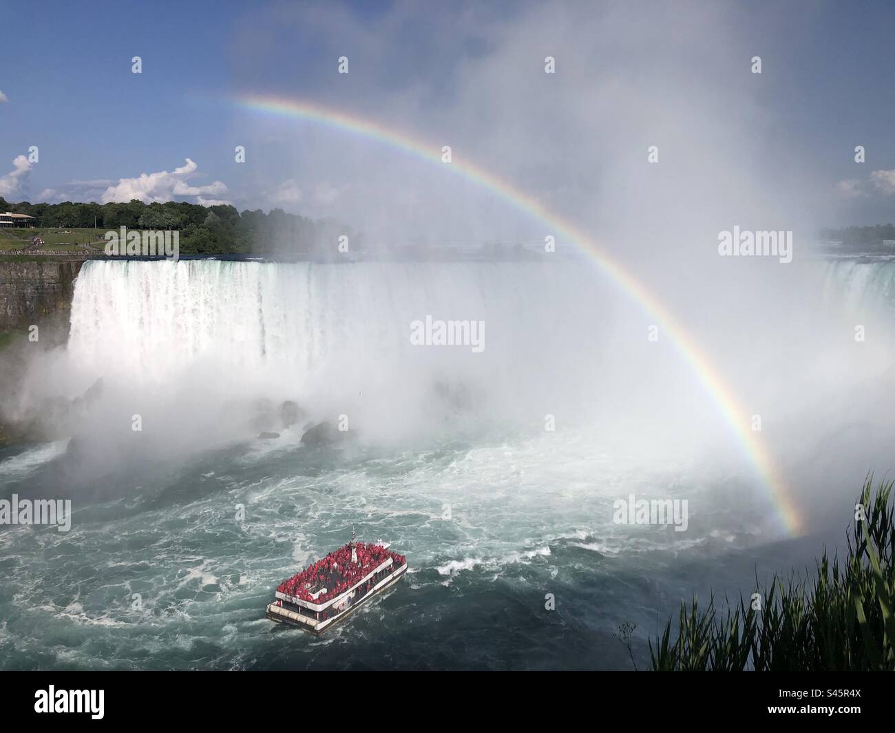 Hornblower boat approaching the Horseshoe Falls, Canada, with a rainbow. - Smartphone Captured Stock Image