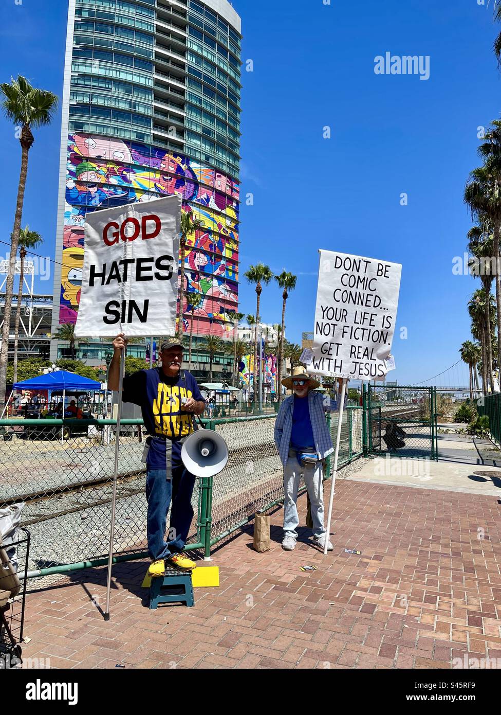 Protestors hold signs in San Diego, California during Comic-Con International day 2 held on July 21, 2023. - Smartphone Captured Stock Image