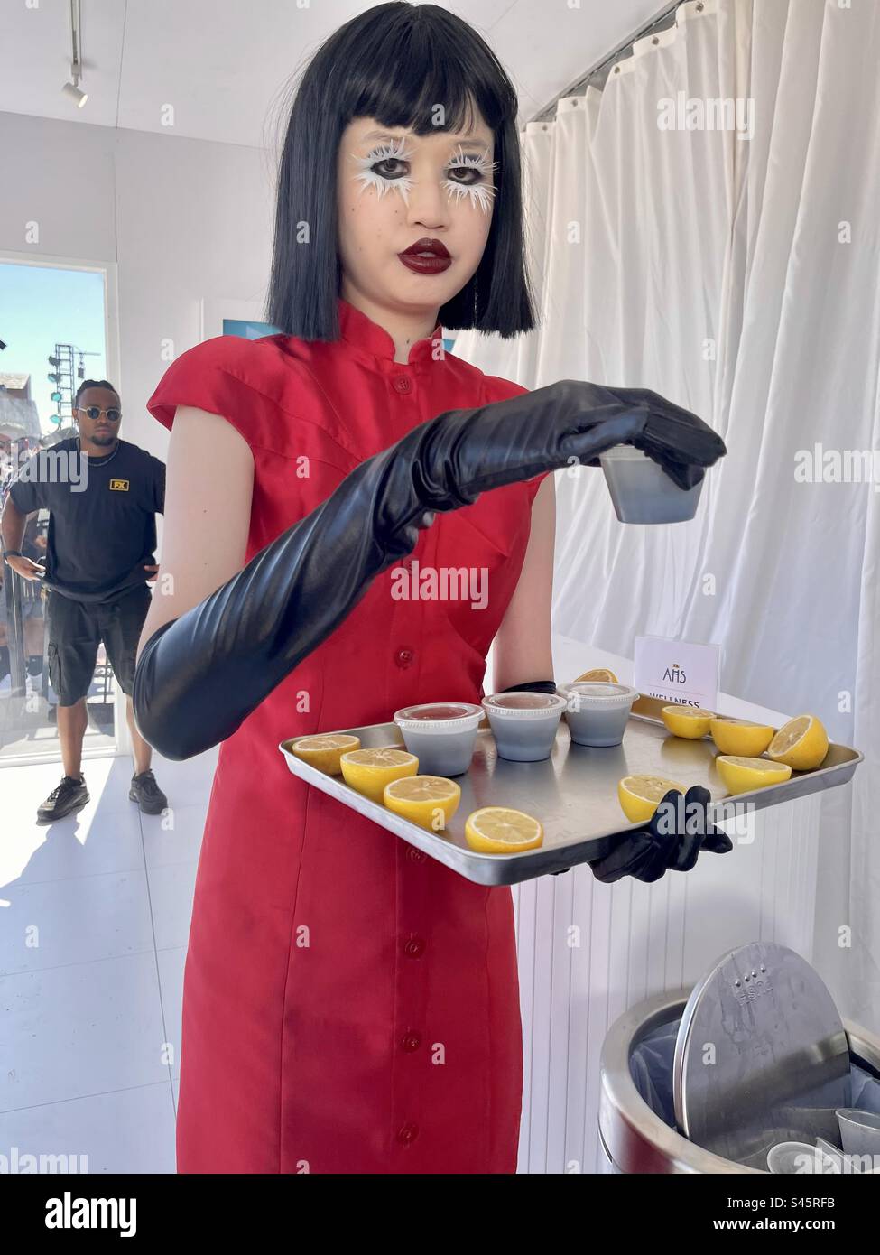 Actor distributes juice health shots during FX’s American Horror Story activation during Comic-Con International day two held on July 21, 2023 held in San Diego, California. - Smartphone Captured Stock Image