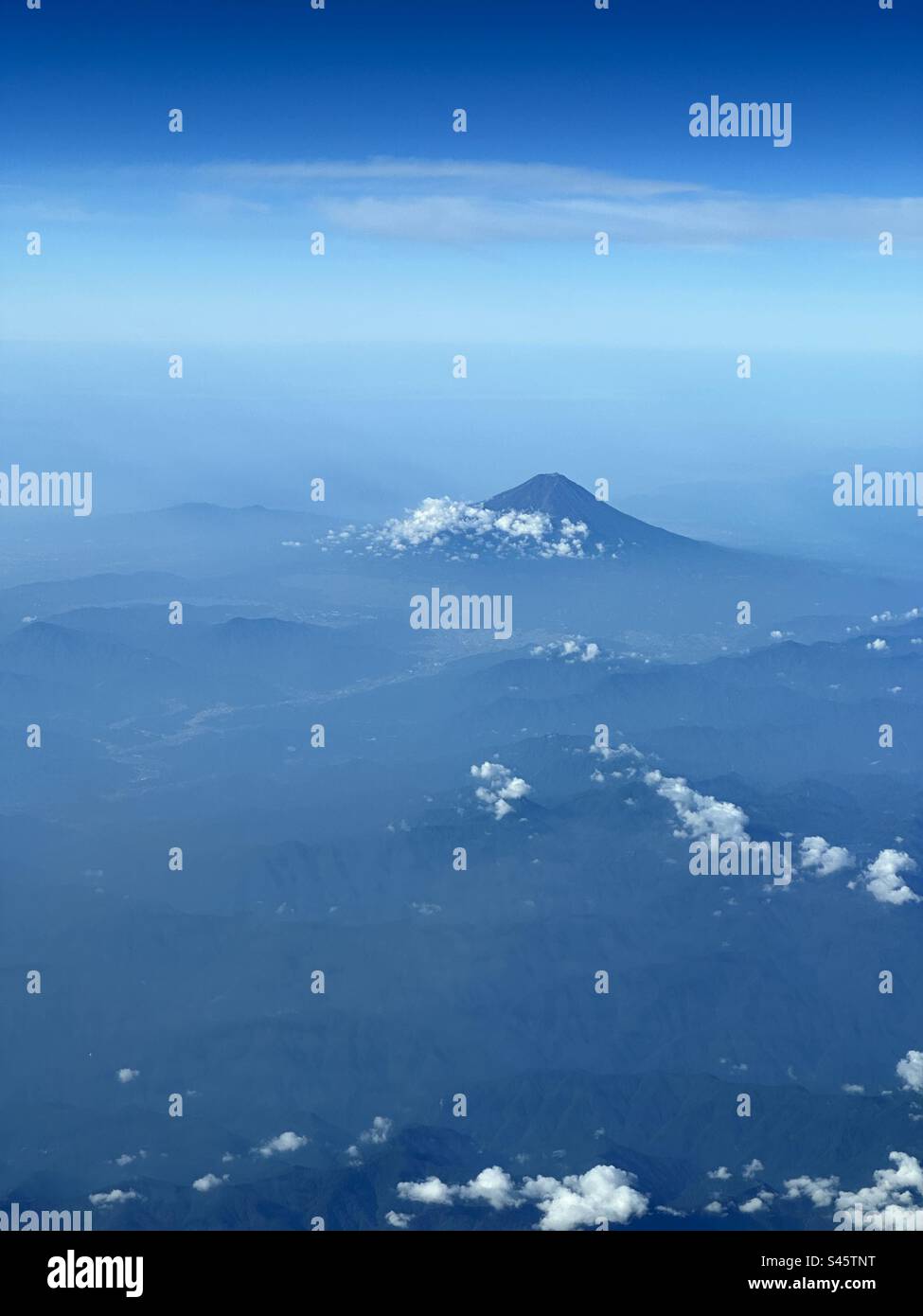 Mount Fuji, Japan on hazy summers day from 37,000feet. - Smartphone Captured Stock Image