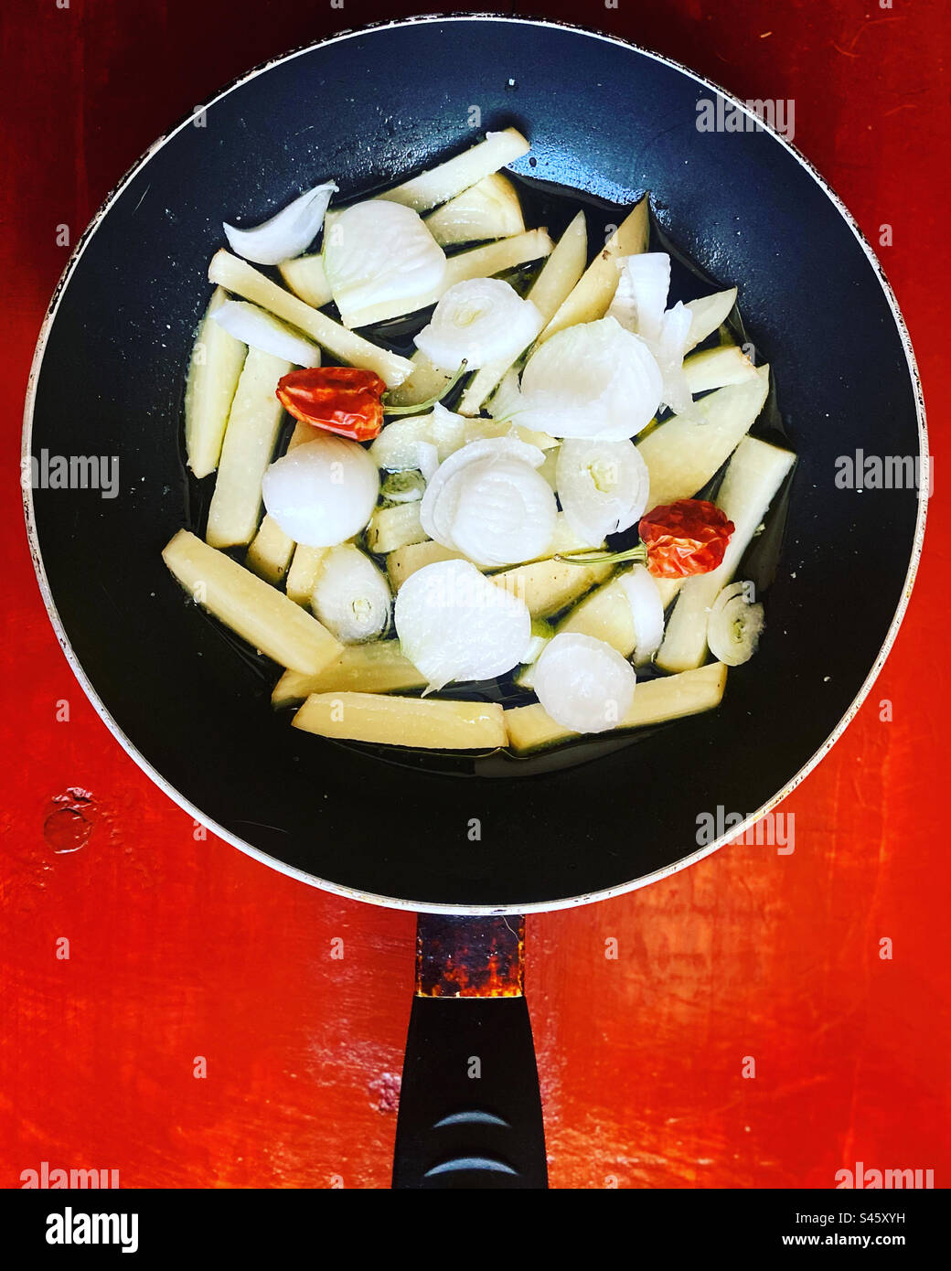Potatoes, onion and red hot chilli peppers ready to be fried in Queretaro, Mexico - Smartphone Captured Stock Image