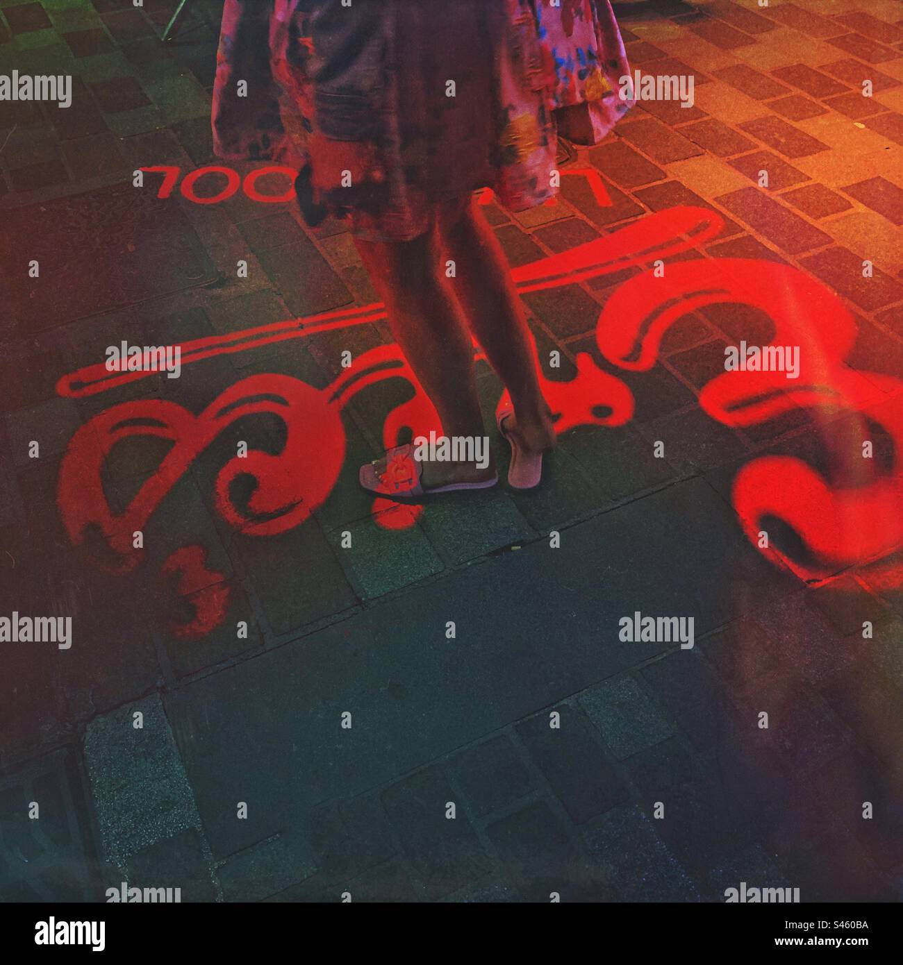 The coloured digital display projections and tourist legs in Mathew Street a music tourist attraction Street in Liverpool England UK - Eric’s Club - music tourism - Smartphone Captured Stock Image