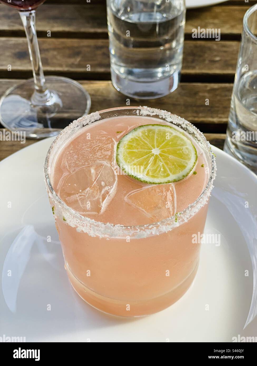 Watermelon margarita, with a slice of lime and rimmed with salt. - Smartphone Captured Stock Image