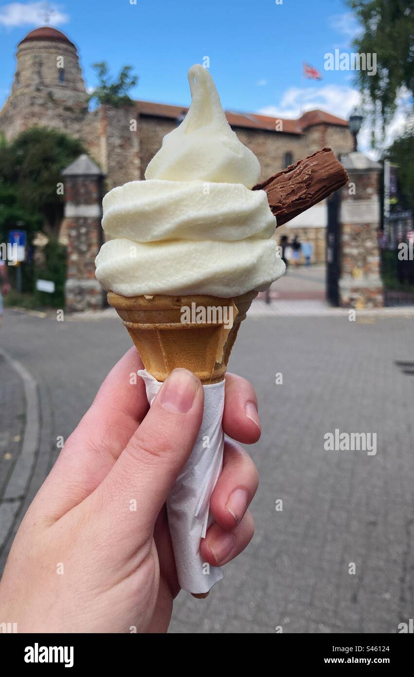 Hand holding a 99 ice cream with a flake, in front of Colchester Castle - Smartphone Captured Stock Image Hand holding a 99 ice cream with a flake, in front of Colchester Castle - Smartphone Captured Stock Image