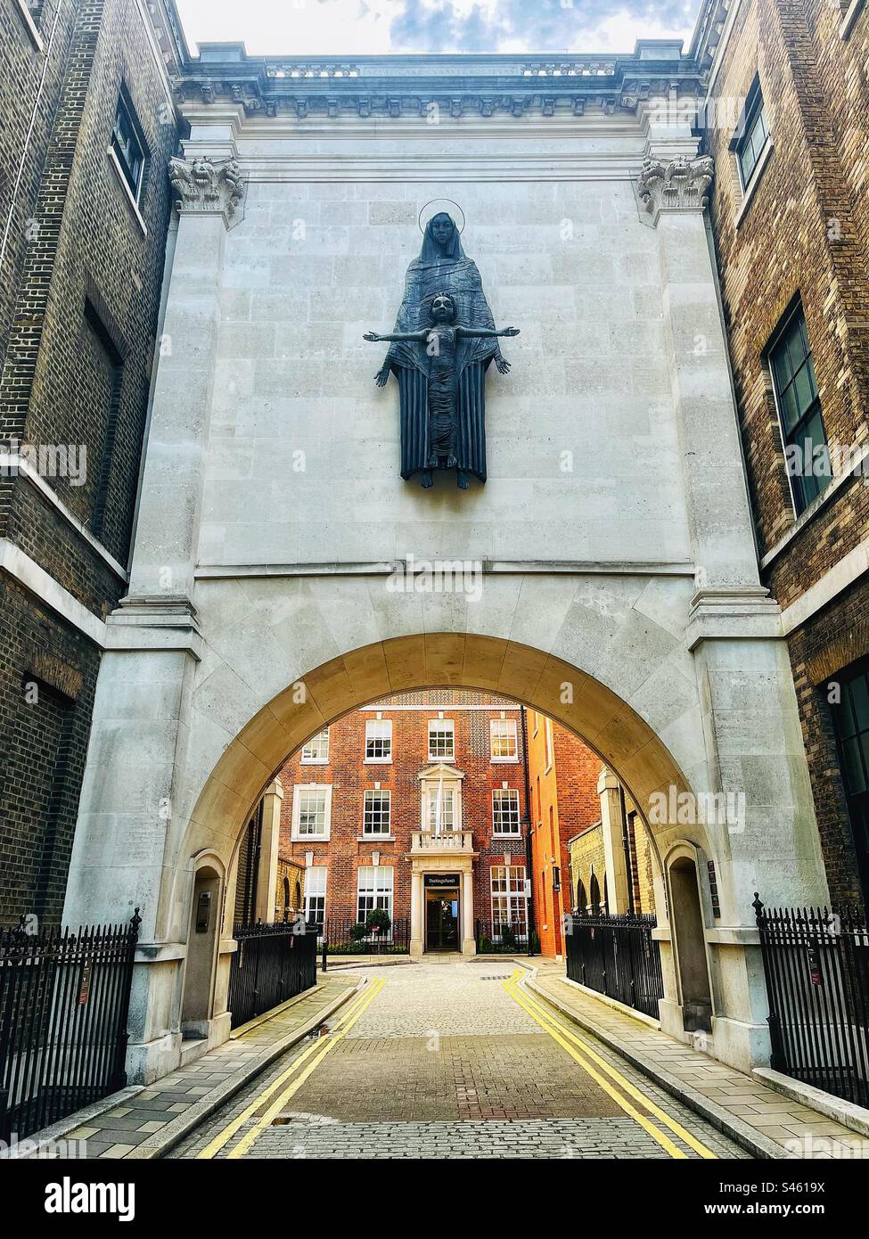 Madonna and Child by Sir Jacob Epstein  looking towards the King’s Fund in Deans Mews in London near Cavendish Square W1 - Smartphone Captured Stock Image
