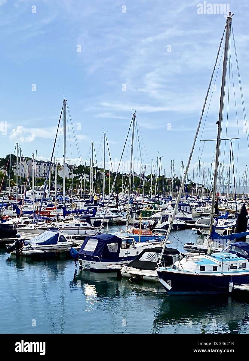 Many varied boats in the large marina at Bangor, Co. Down in Northern Ireland. On a beautiful sea front, Bangor is a premier sailing destination and a popular resort with Pickie Fun Park adjacent. Stock Photo