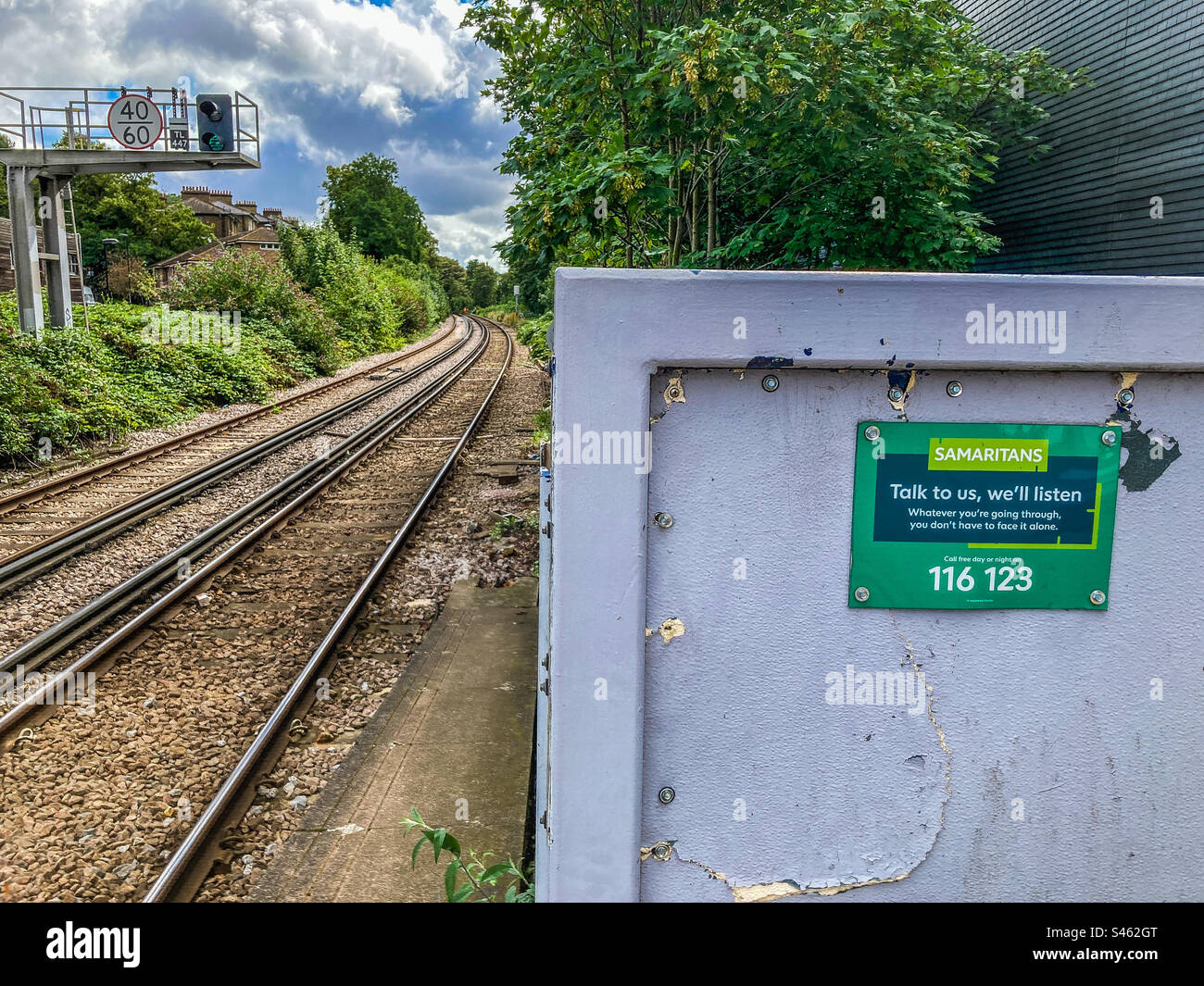 A sign from the Samaritans, at the end of the platform at Lewisham Station - Smartphone Captured Stock Image