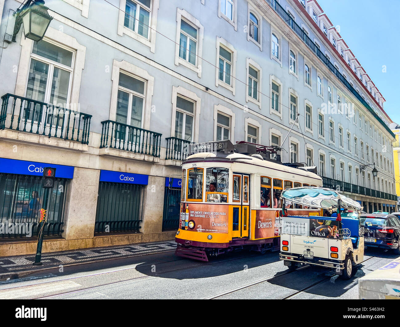 Yellow tram and tuk tuk in Lisbon Portugal Stock Photo