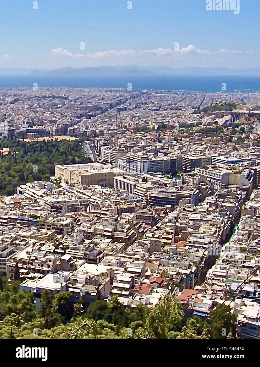 The city of Athens, Greece, looking west to the Saronic Gulf & Peloponnese. Taken from Mt Likavittos, Parliament is in the centre & the Acropolis, Parthenon  & Temple of Olympian Zeus are nearby. Stock Photo