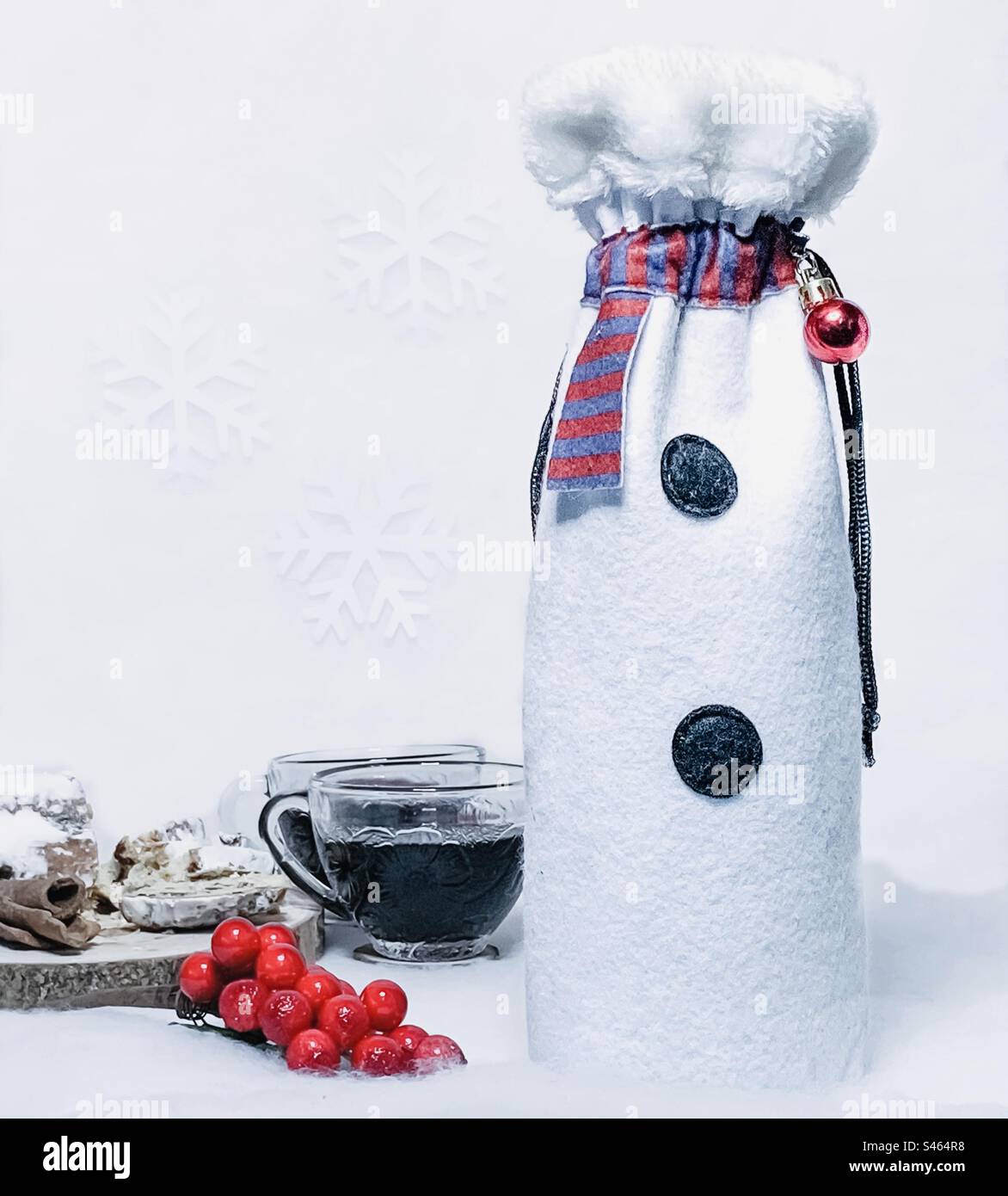 Festive gift display, with mulled wine & berries and snowman themed bottle bag - Smartphone Captured Stock Image