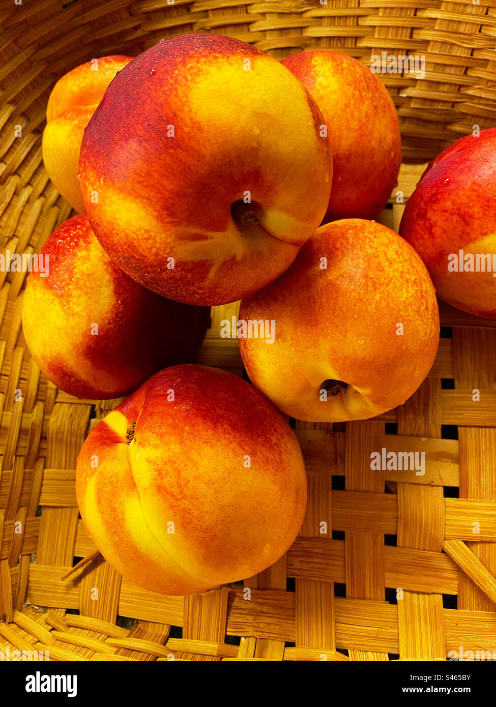 Ripe, fresh nectarines in a wicker basket - Smartphone Captured Stock Image