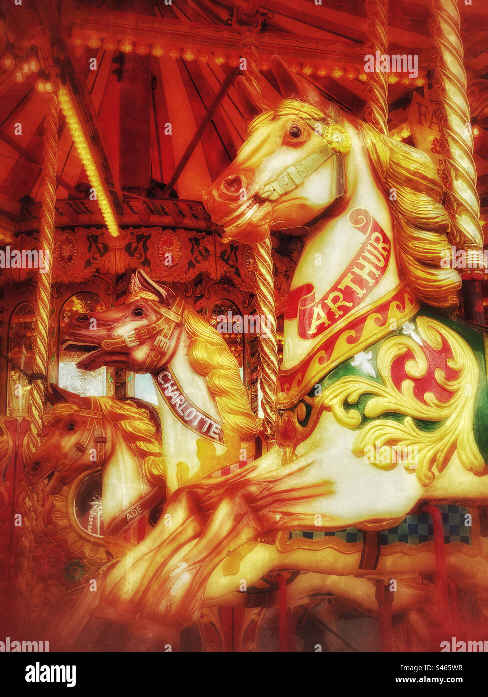 Moody and atmospheric image of 3 horses on the carousel of a roundabout fun fair ride. Photo ©️ COLIN HOSKINS. - Smartphone Captured Stock Image
