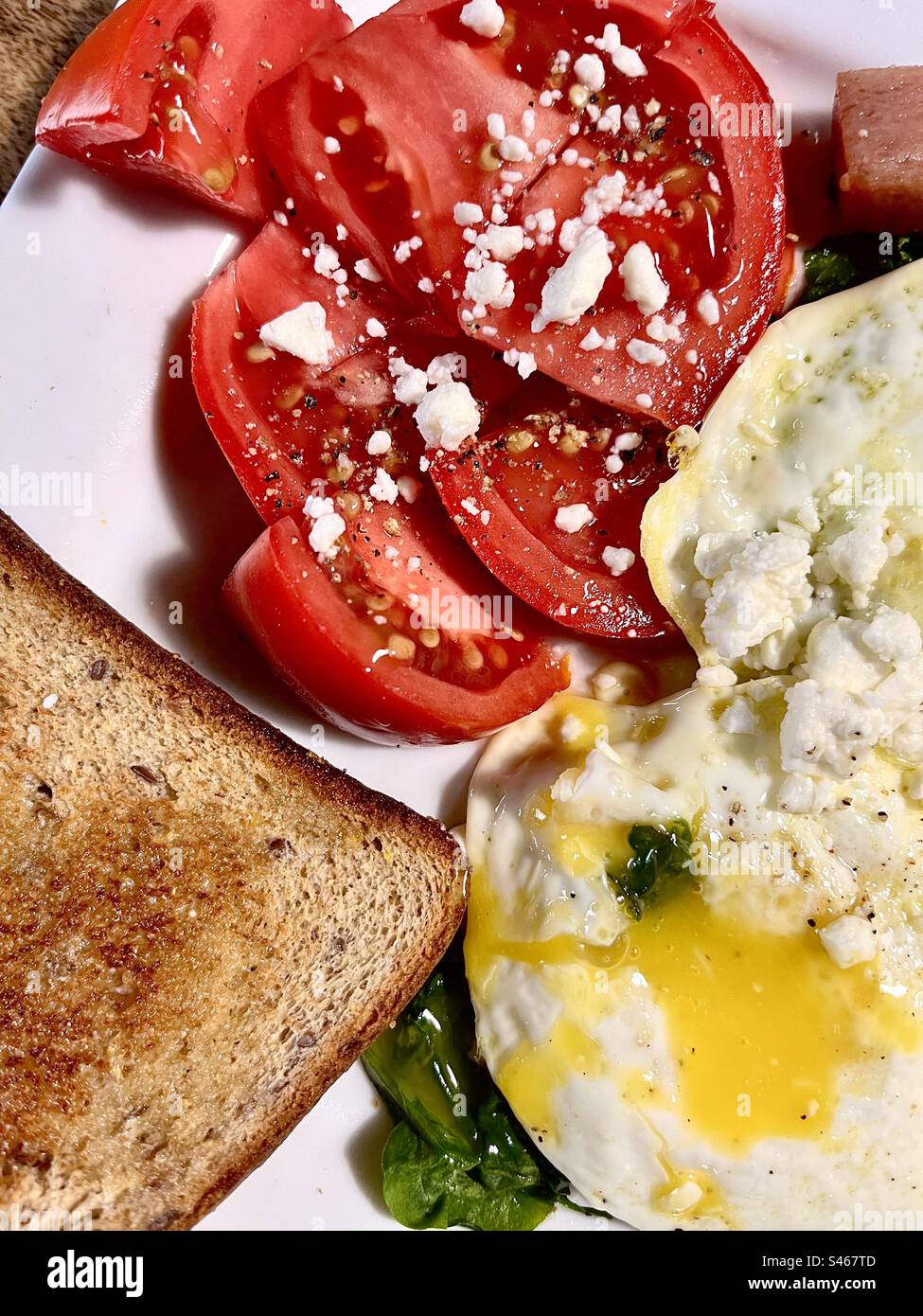 Healthy breakfast , eggs over easy with toast spinach and tomatoes. - Smartphone Captured Stock Image