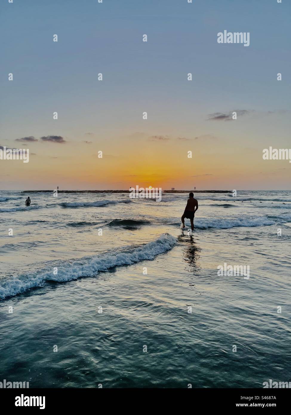 A beautiful sunset over the Mediterranean Sea seen from the beach in Tel-Aviv, Israel. Stock Photo