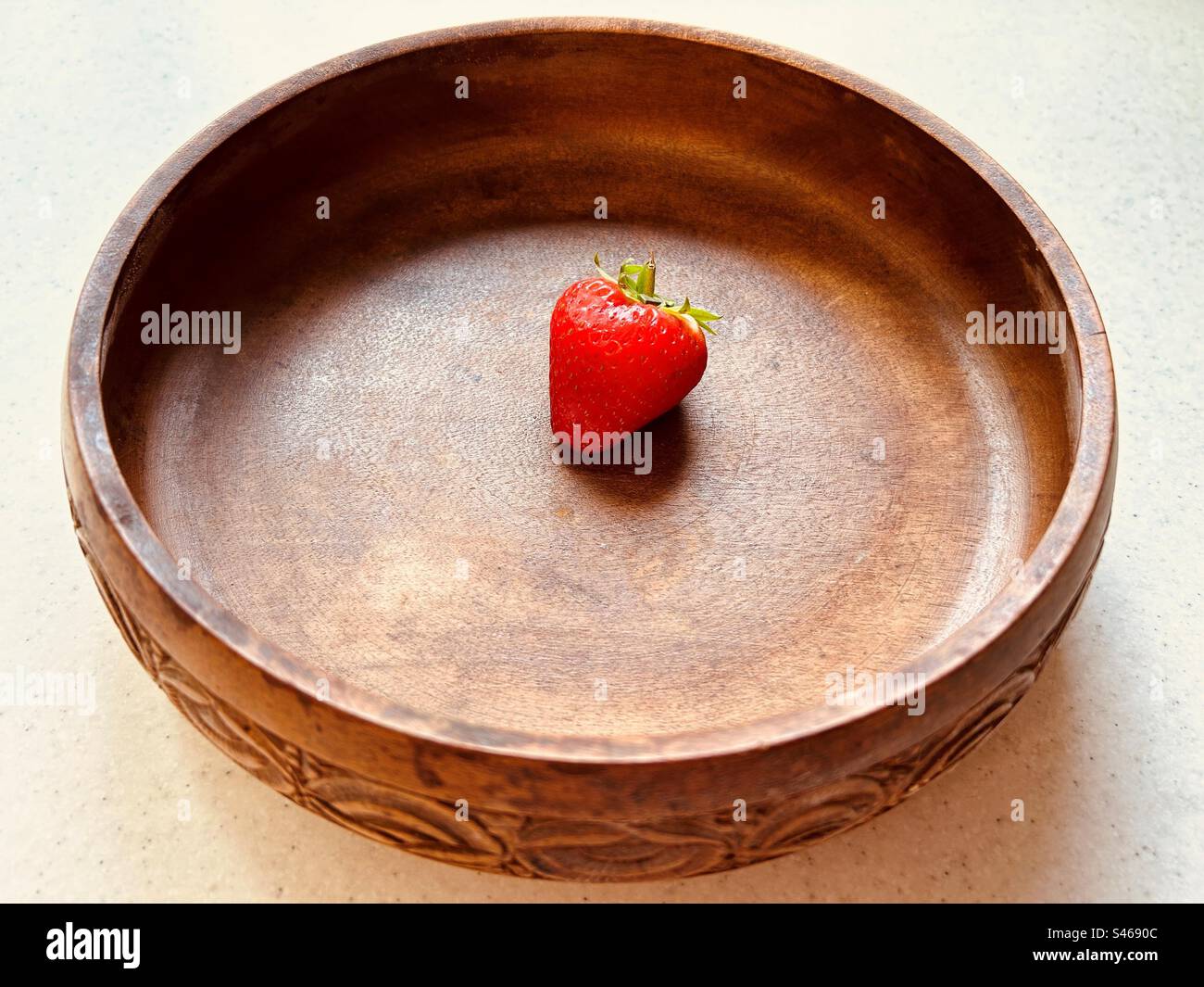 One strawberry in a circular wooden bowl. Fresh, red, juicy, sweet, nutritious, summer fruit. - Smartphone Captured Stock Image