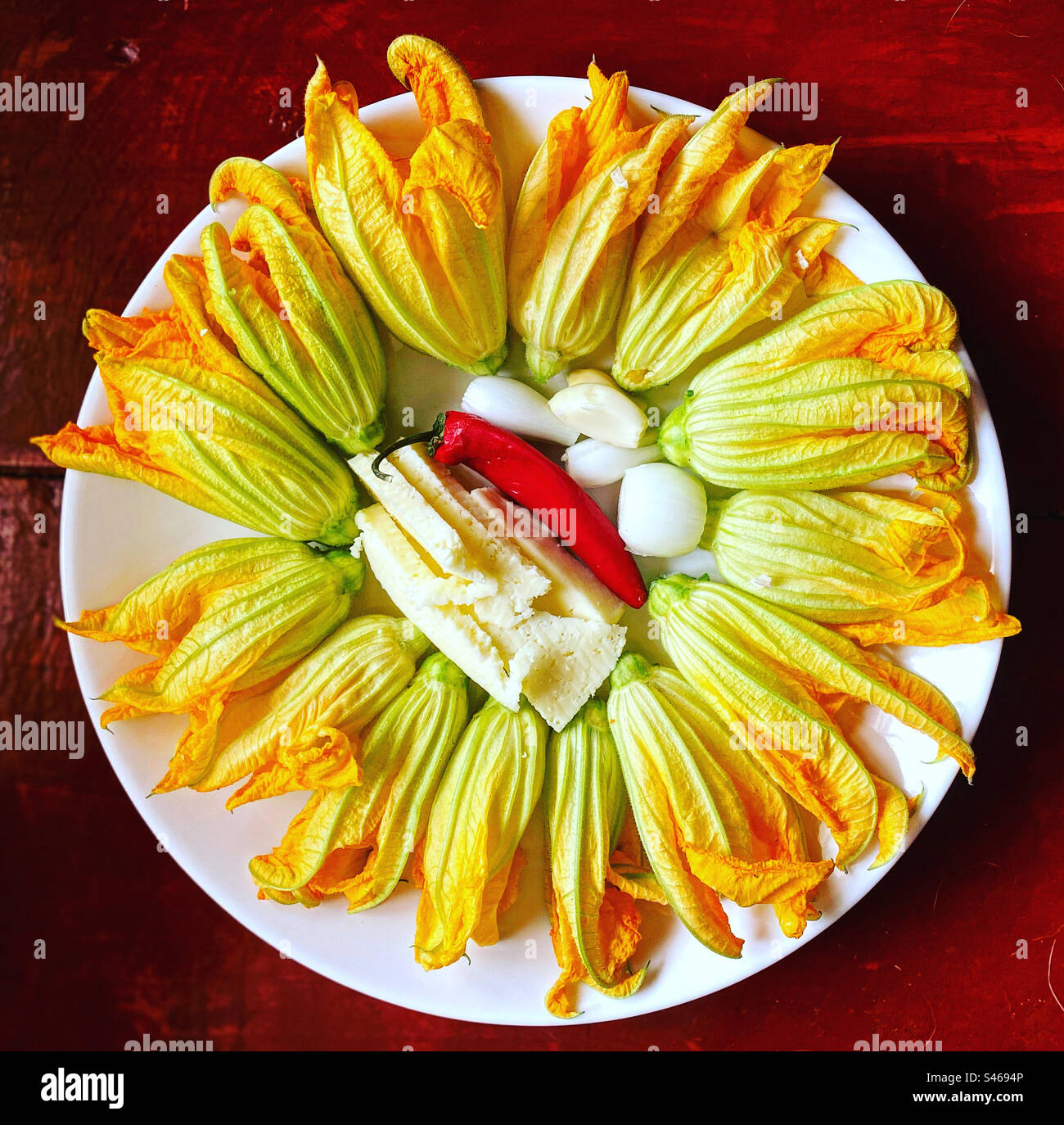 Pumpkin flowers, chesse, a red hot chilli pepper and onion ready to be grilled in Mexico Stock Photo