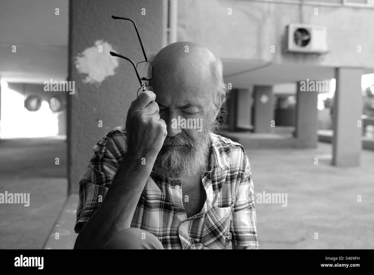 Depressed senior man in town Stock Photo
