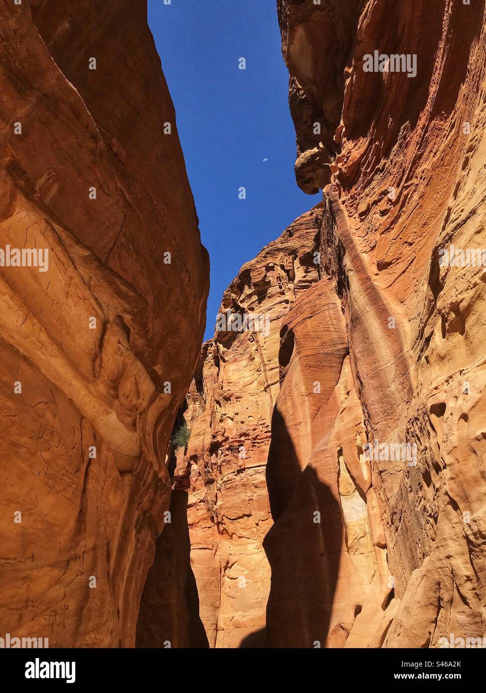 Petra Jordan red sandstone rock formations along the Siq pathway that leads to the ancient Treasury. - Smartphone Captured Stock Image