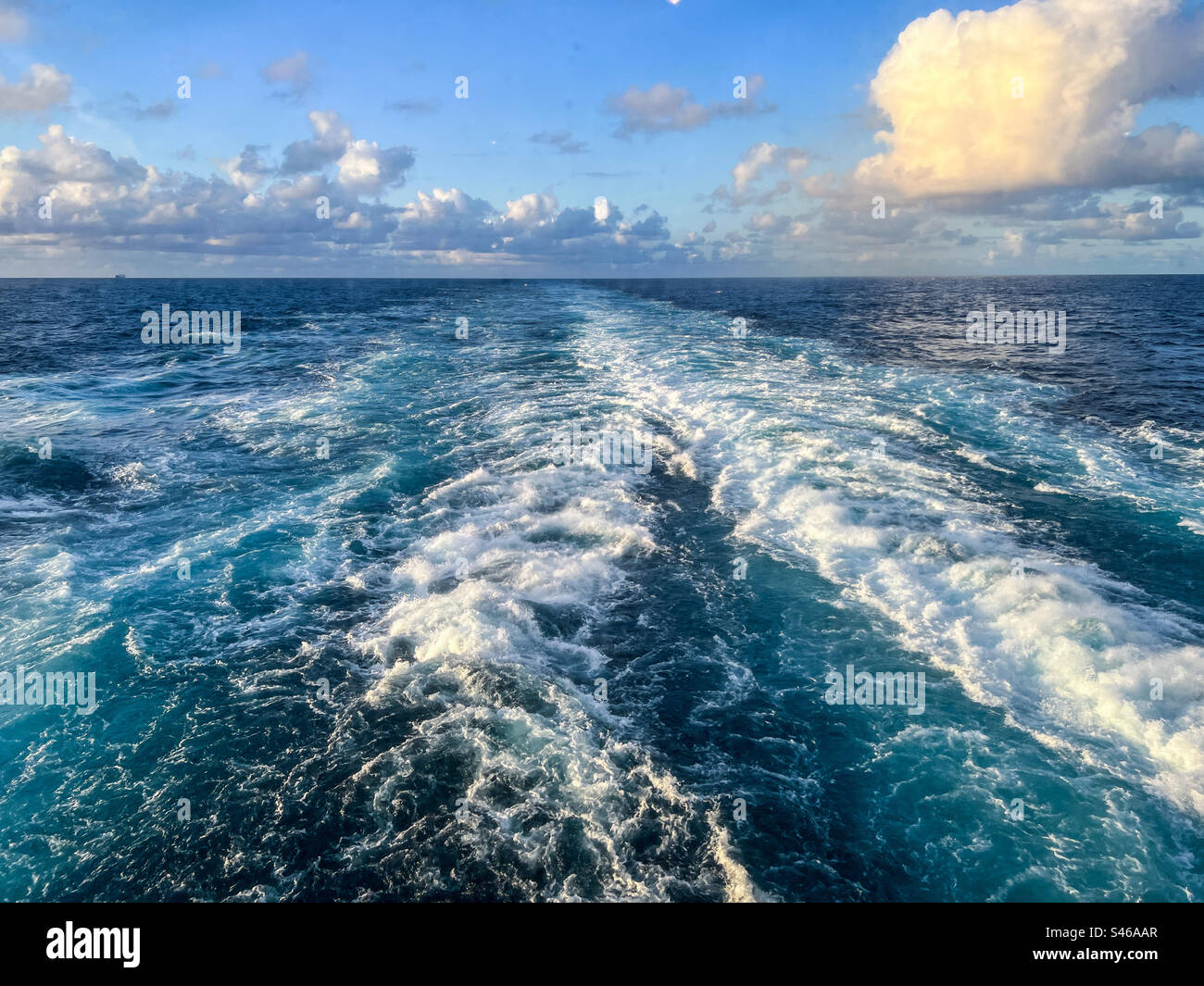 Rear view of a cruise ship with wake at sunset - Smartphone Captured Stock Image