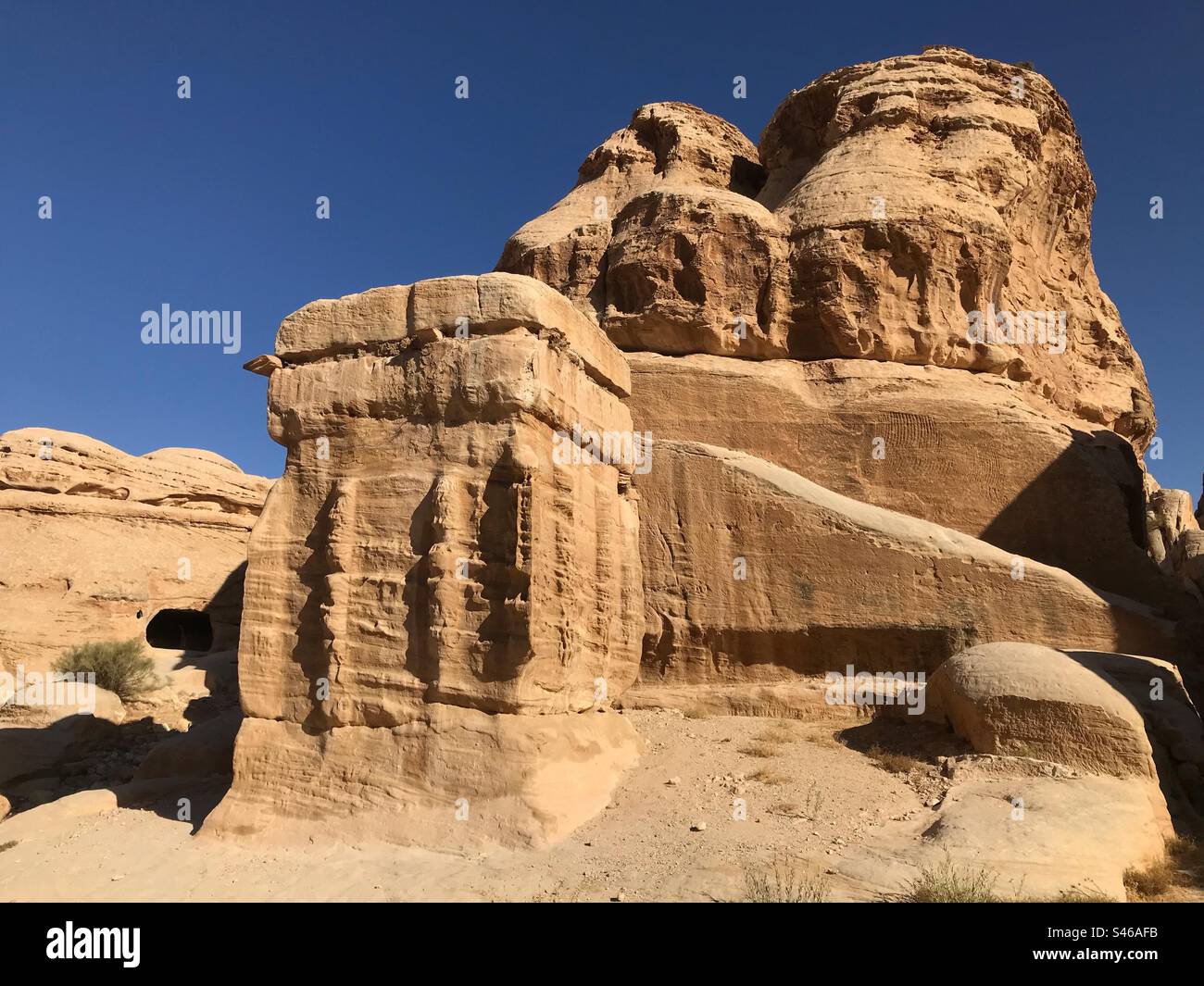 Petra Jordan one of the ancient Djinn blocks carved by the Nabatean people at the entrance to the Siq. - Smartphone Captured Stock Image