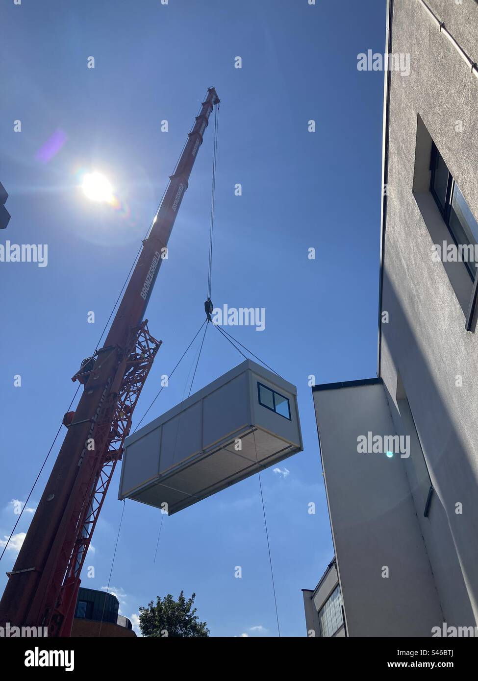 Crane lifting a modular building Stock Photo Alamy