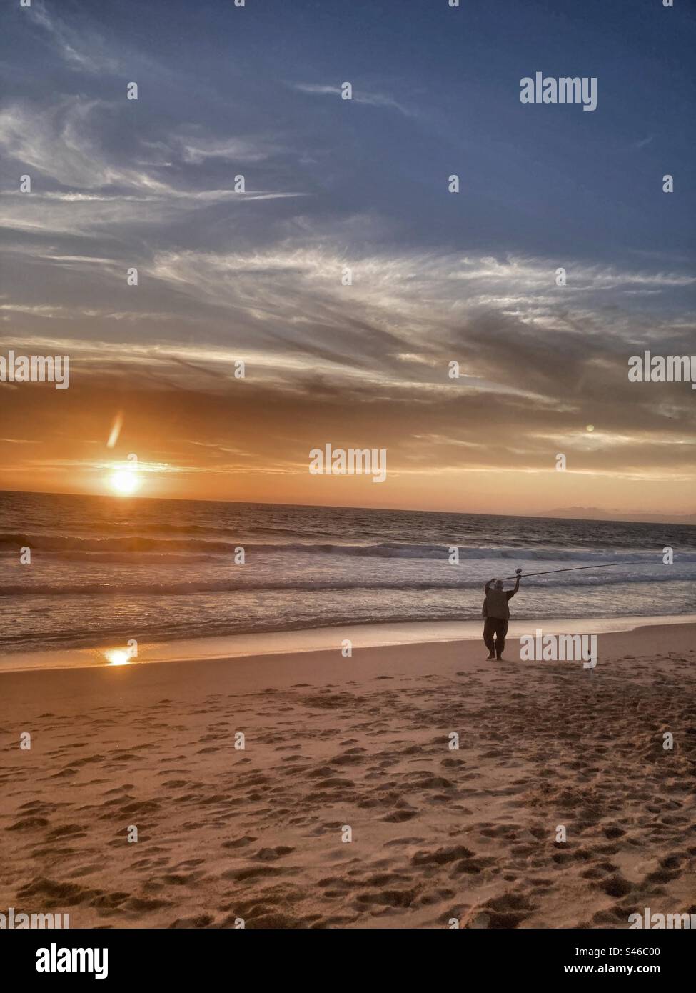 Portuguese fisherman at sunset in Lagoa de Albufeira beach ( Sesimbra region,Setubal county,south of Portugal). - Smartphone Captured Stock Image