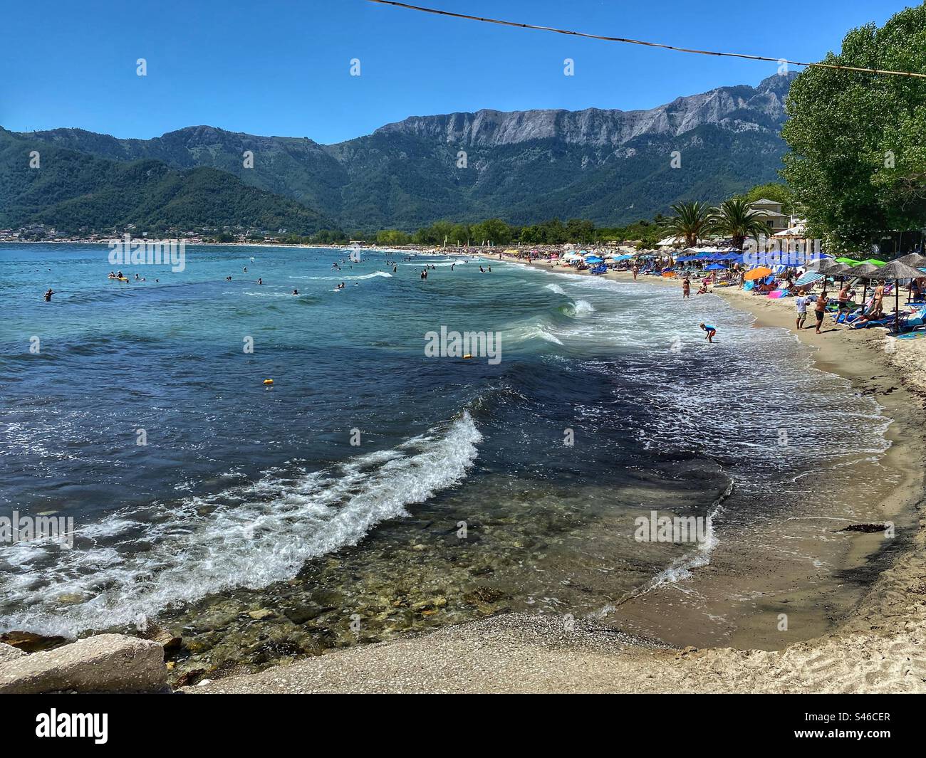 Sea view with waves and mountains on Golden Beach on Thassos island, Greece. - Smartphone Captured Stock Image