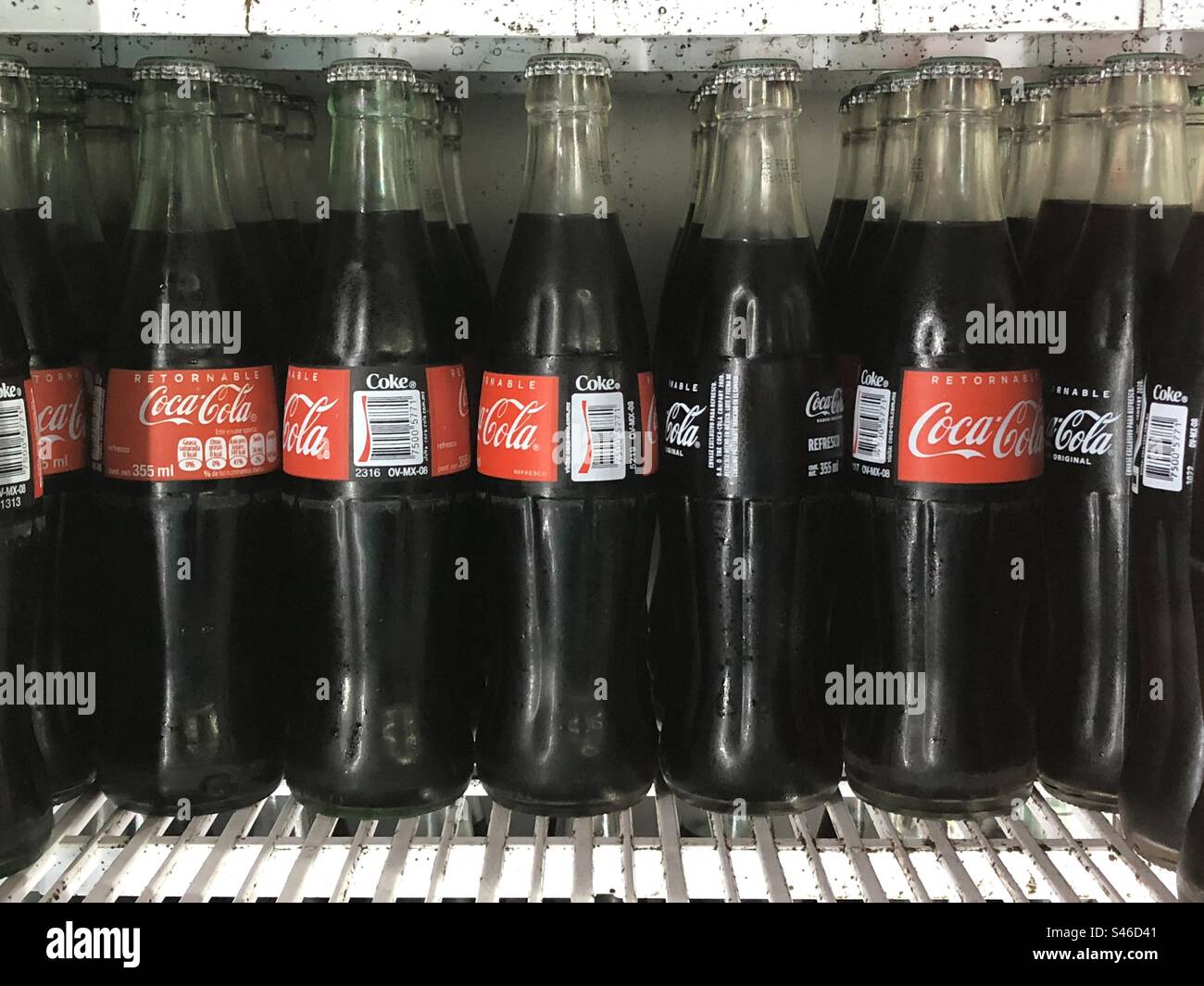 CocaCola bottles with Spanish labels in the refrigerator, Mexico City